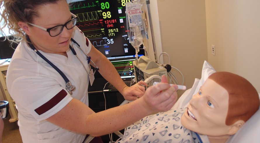 Roseman University ABSN student working with patient simulation manikin